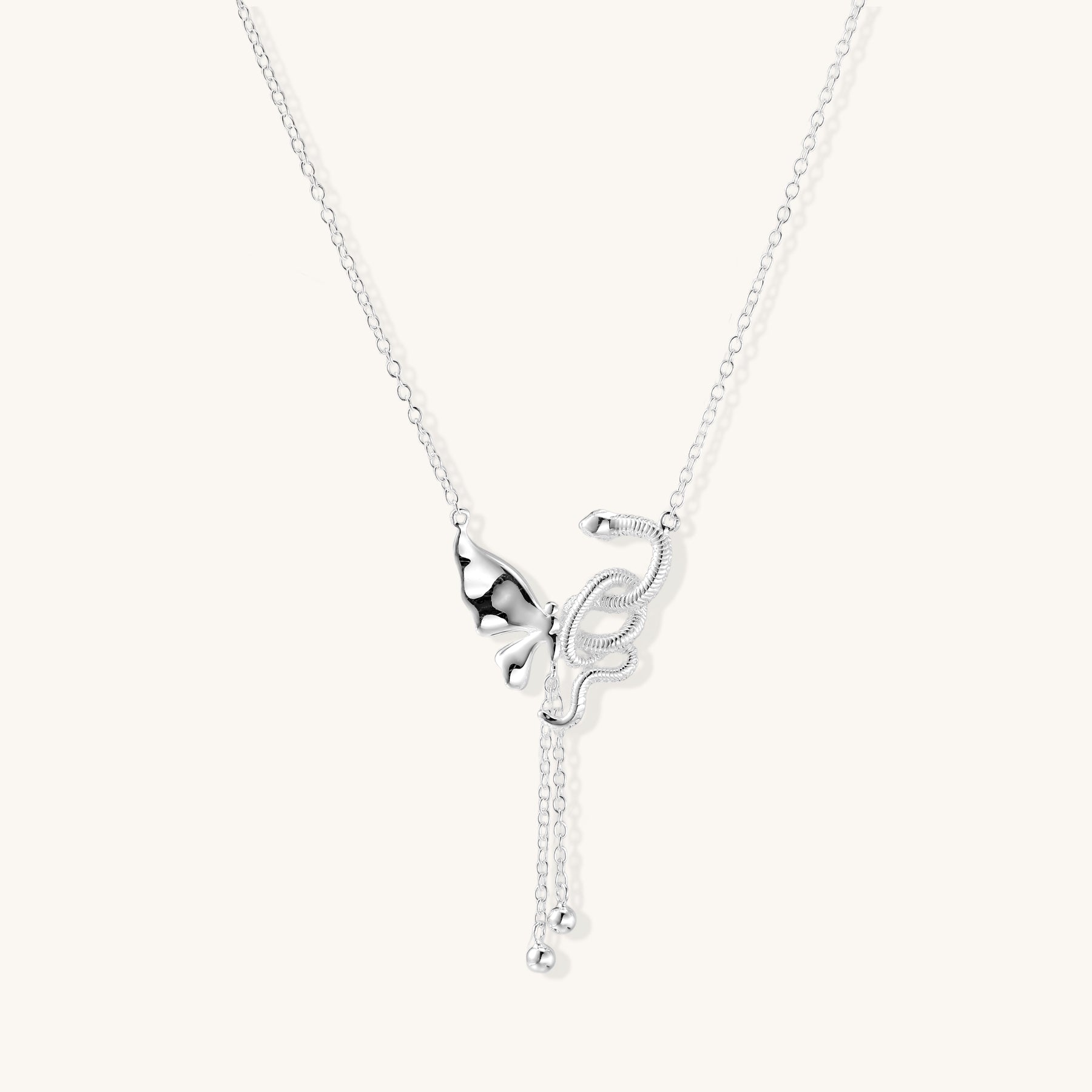 Delicate sterling silver butterfly pendant necklace with textured wing details and adjustable chain on white background