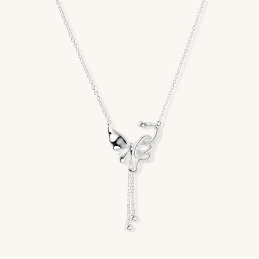 Delicate sterling silver butterfly pendant necklace with textured wing details and adjustable chain on white background