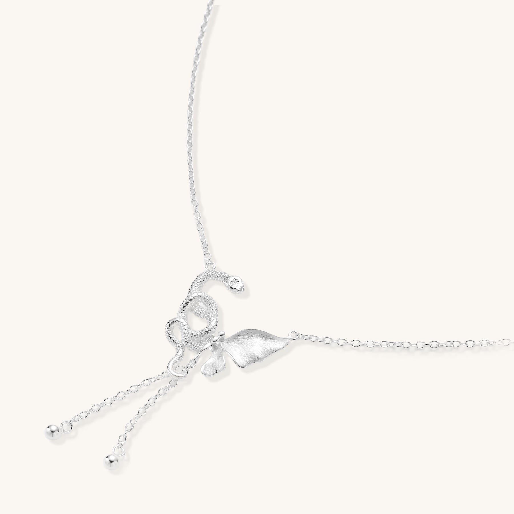 Delicate sterling silver butterfly pendant necklace with textured wing details and adjustable chain on white background