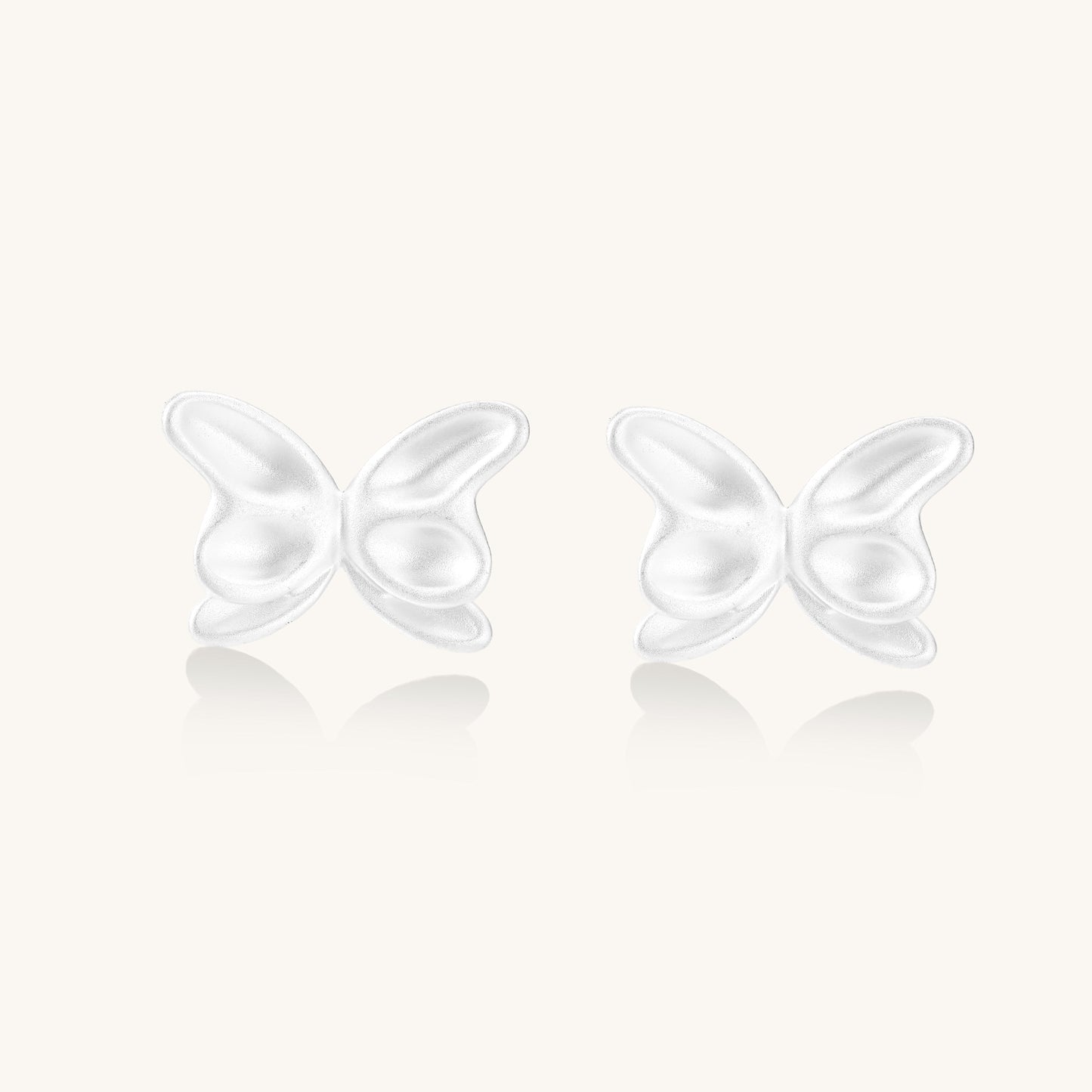 Delicate sterling silver butterfly stud earrings with intricate wing details on a neutral background.