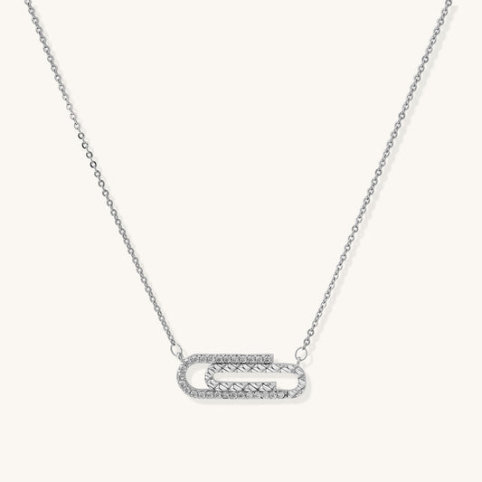 Delicate 14K gold plated chain necklace with crystal-accented carabiner-style pendant on white background