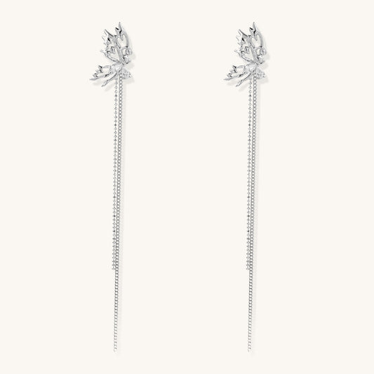 Long gold-plated earrings with star motifs and delicate chain tassels cascading down, featuring zirconia accents.