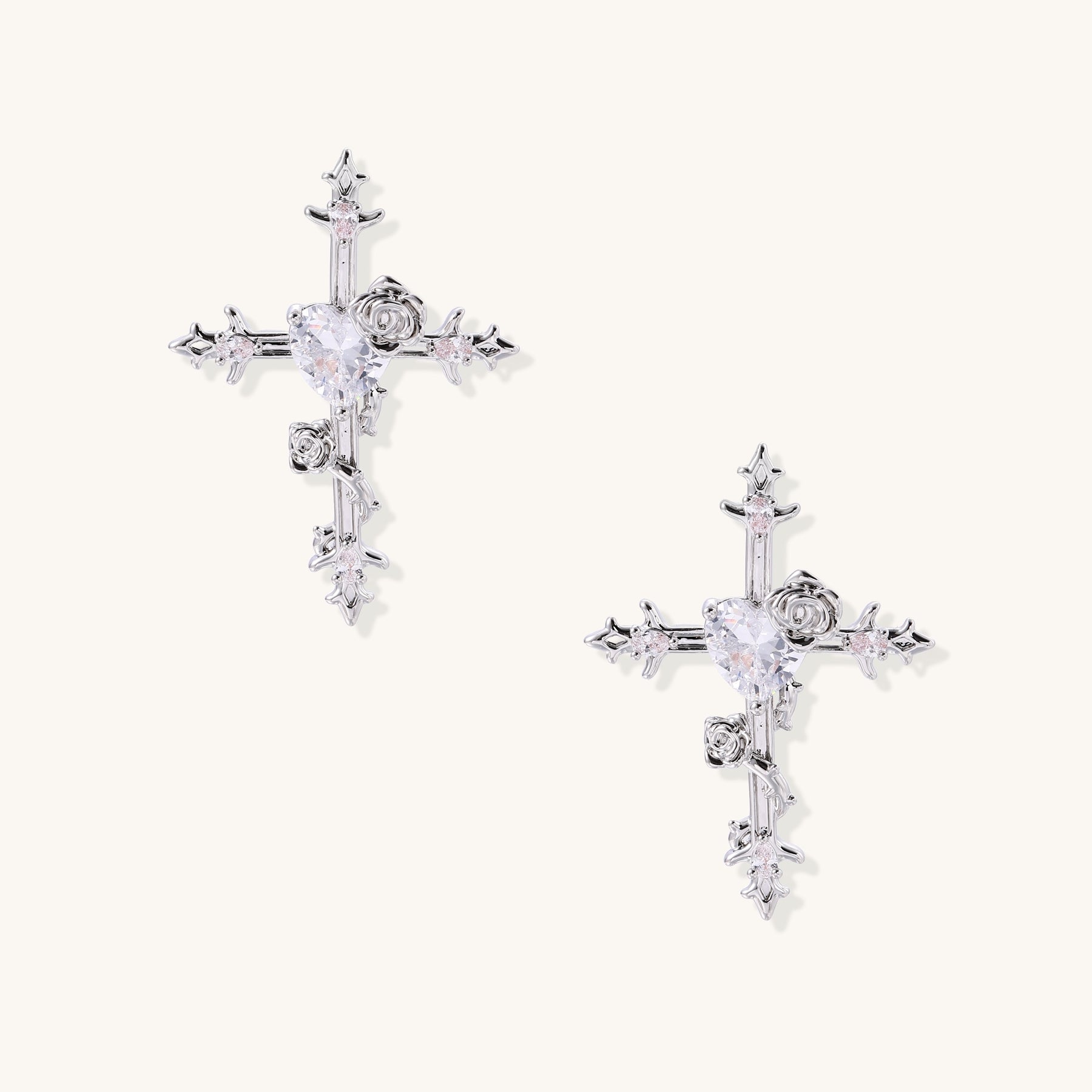 Ornate cross-shaped dangle earrings with gold roses and sparkling zirconia stars on silver-toned base with hoop closures.