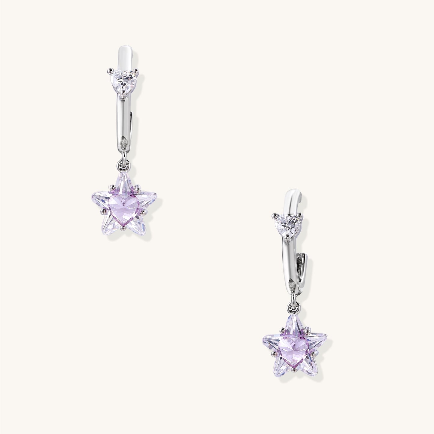 Drop earrings with purple star-shaped zirconia stones and clear teardrop accents in gold-plated brass setting