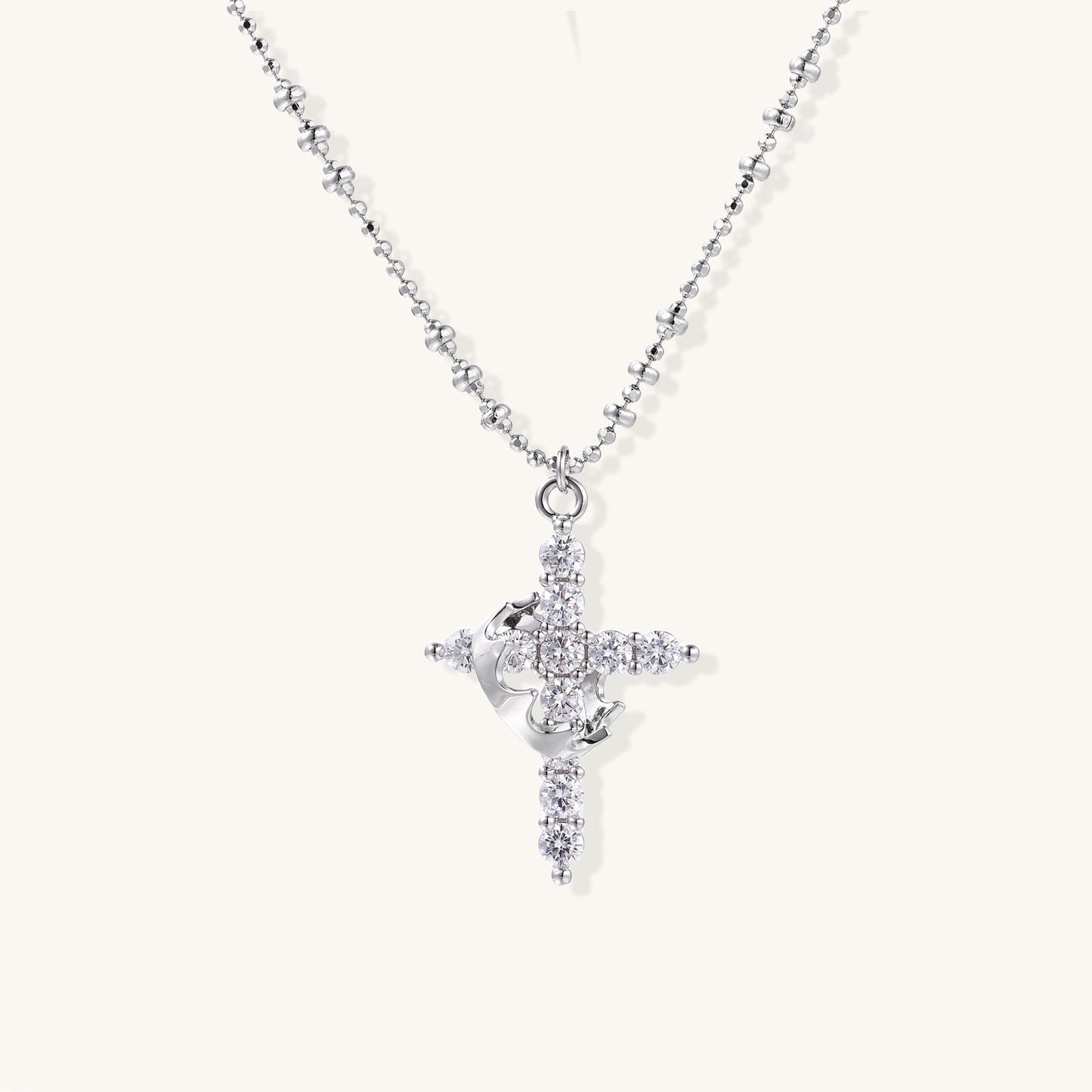 Close-up of 18K gold plated cross necklace with zirconia crystals arranged in cross pattern on ball chain
